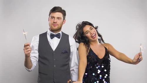 Happy Couple Celebrates with Sparklers Indoors