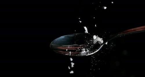 Drug, Cocaine in spoon against black background, Slow motion 4K