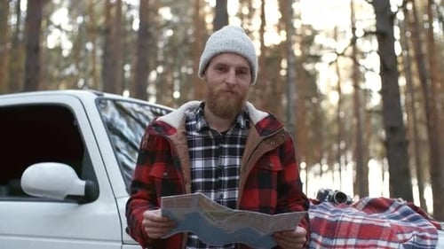 Portrait of Bearded Traveler Holding Map