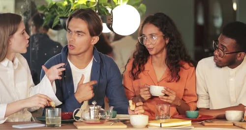 Crop View of Cheerful Multi Ethnic Colleagues Communicating and Sharing Ideas While Eating in Cosy