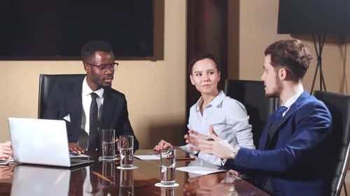Diverse Team Discussing Business in Bright Conference Room