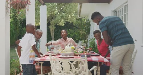 Family Meal at Outdoor Table in Summer