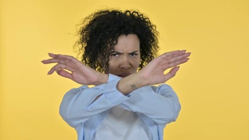 Woman Makes No Gesture on Yellow Background
