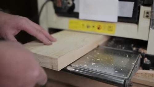 Male Carpenter Working with Planing Machine in Workshop