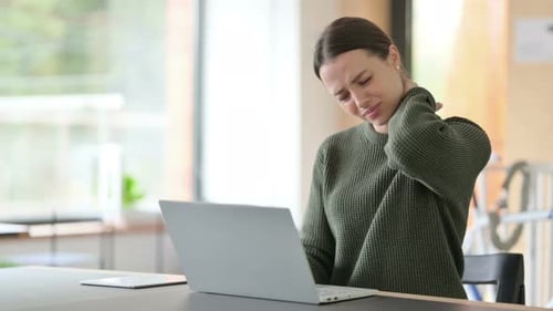 Young Adult Woman Experiences Neck Pain Using Laptop