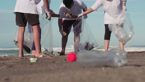 Collecting Trash At Coastline