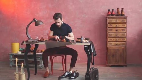 Artisan Man Crafting Custom Leather Footwear Indoors