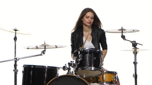 Young Woman Energetically Playing Drums on White Background