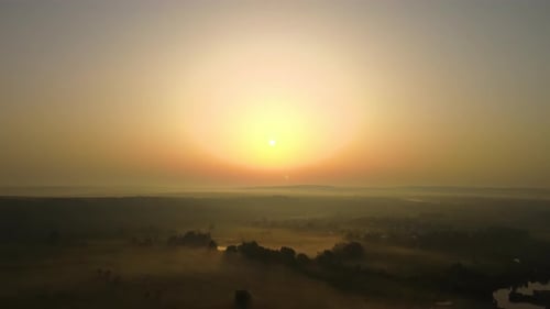 Aerial Landscape View of Sunny Morning Over Foggy Green Fields