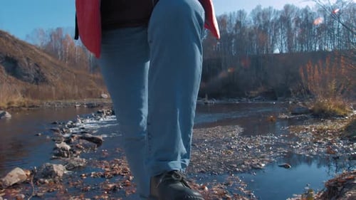 Woman Walks Upward on Ground Road