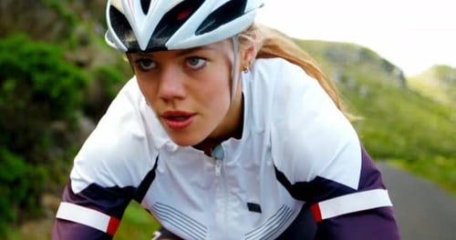 Female cyclist cycling on a countryside road