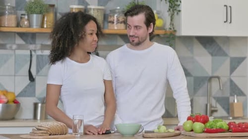 Couple Talking in Bright Kitchen