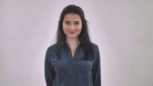 Woman Smiling and Holding a Wrapped Gift