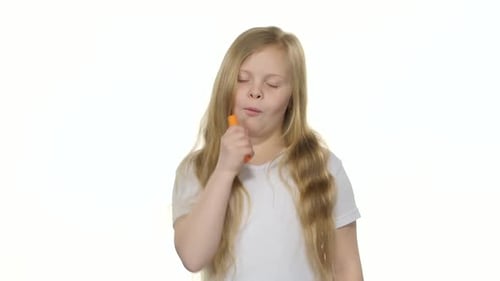 Girl Eating a Carrot and Giving Thumbs Up