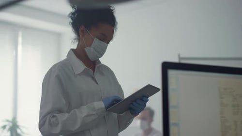 Doctor Woman Checking Analysis Results on Tablet Standing Clinic Office Close Up