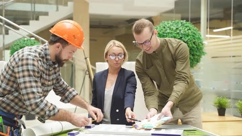 Engineers Working in Office with Building 3d Model