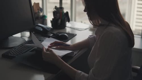 Young Employee Works with Documents