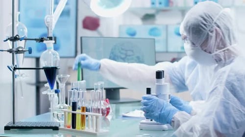 Scientists Researching with Microscope in Modern Laboratory