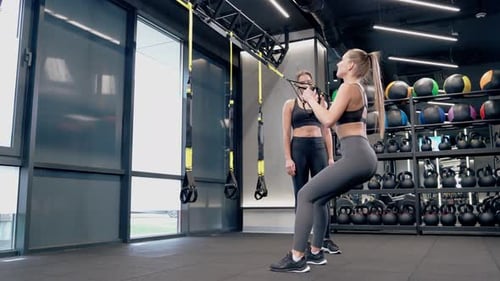 Slim Girlfriends Doing Workout with TRX System