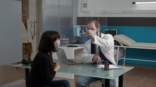 Männlicher Arzt erklärt Frau die Diagnose eines Röntgenscans
