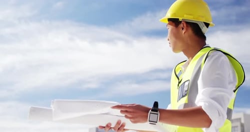 Construction Engineer Reviewing Blueprints in Urban Setting