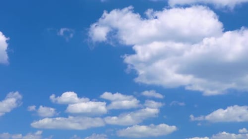 Serene Blue Sky and Fluffy White Clouds