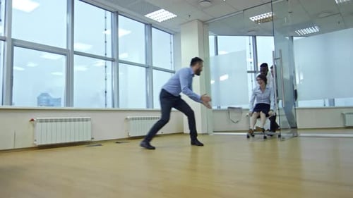 Joyful Colleagues Having Fun in New Empty Office