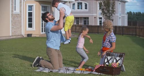 Family Picnic Fun on Suburban Lawn
