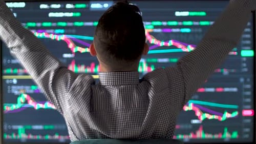 Back View of Trader Celebrating Successful Day at the Stock Market