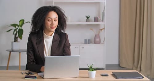 Afro American Businesswoman Working Remotely From Home Office with Laptop Pauses Remembering