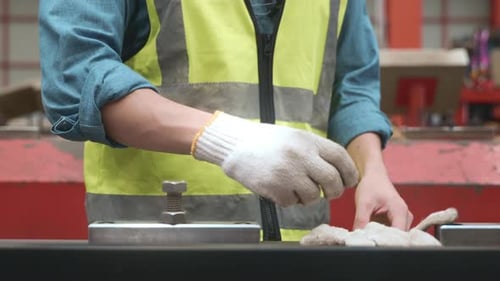 Close up hands of engineer worker man putting gloves on his hand while working
