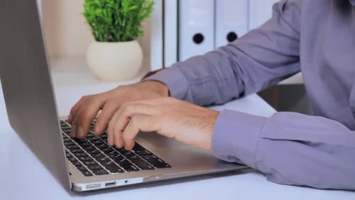 Pessoa irreconhecível trabalha no computador