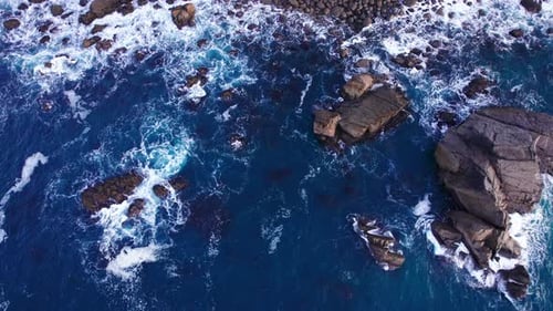 Aerial View of the Ocean Waves Hitting Against the Rocks