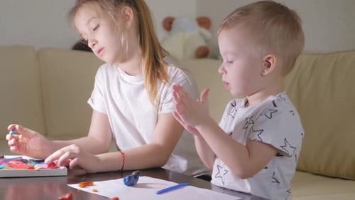 Children Playing with Clay at Table Together