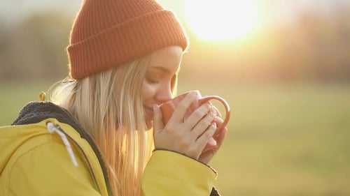 Happy, smiling woman drinking coffee.
