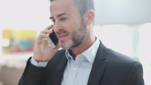 Businessman Talking on Phone in an Office Setting