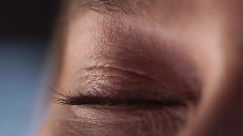 A Woman's Beautiful Eye Squints in the Sun. Macro Close Up of the Eye