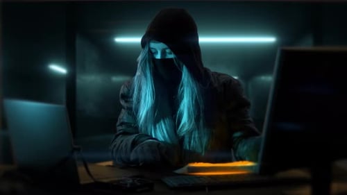 Mysterious Hacker Typing on a Computer Keyboard