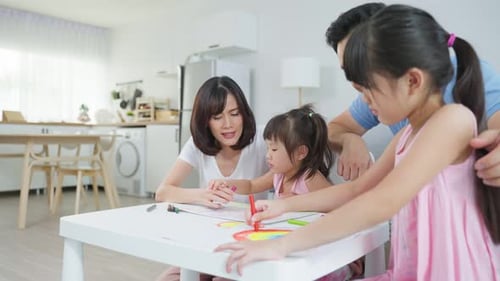 Family Drawing Together at Table in Home