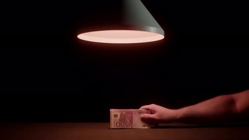 Hand Exchanges Cash Money Under Lamp Light