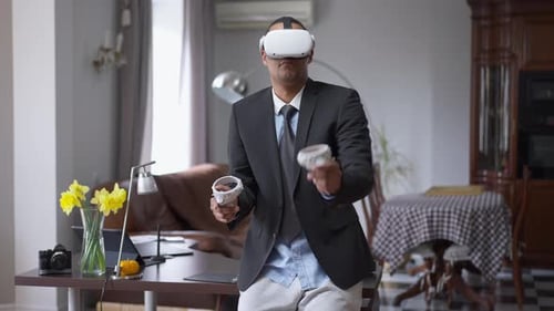 Positive Young African American Man in VR Headset Having Break in Home Office on Coronavirus