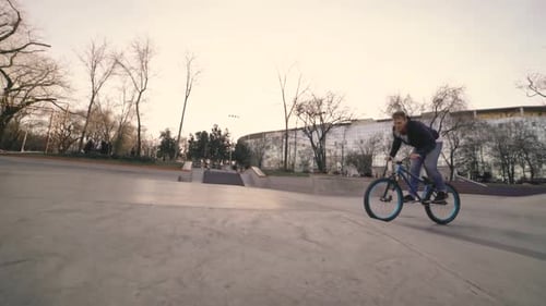 MTB Bicycle Rider Does Various Tricks While Riding in Skatepark