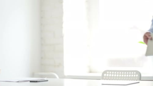 Man Coming Back Opening Laptop in Office