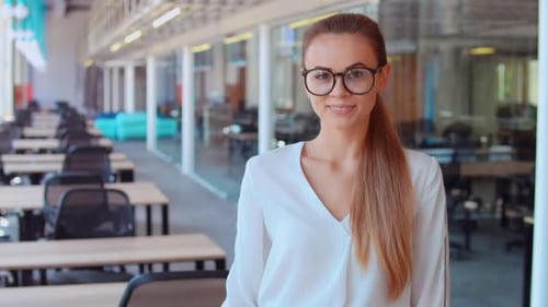 Smiling Woman Gives Thumbs Up in Office