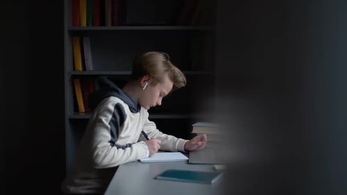 Teen Boy Studies at Desk in Home Office