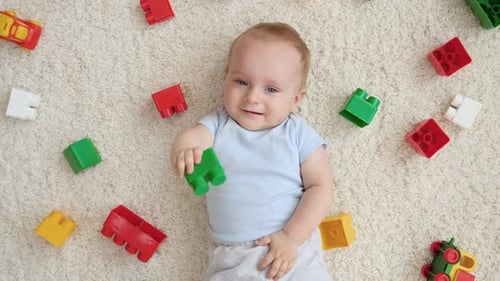 Smiling Baby Playing with Colorful Building Blocks