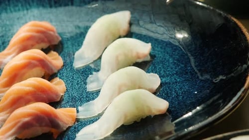 Close-Up of Sushi Being Picked Up with Chopsticks