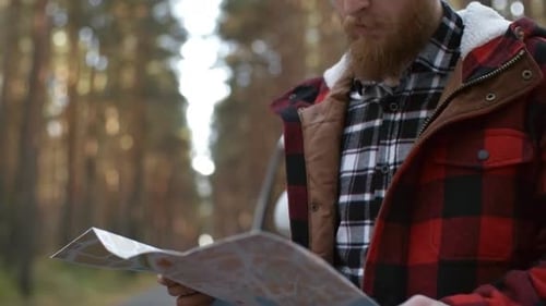 Portrait of Bearded Young Man with Map