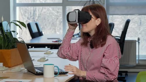Woman Puts on VR Headset at Office