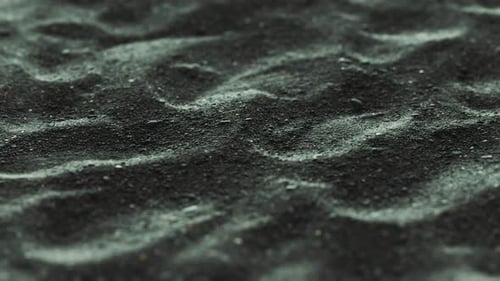 Subtle Rippling Black Sand Seamless Loop Motion Background